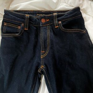 Dark wash skinny jeans with bright orange stiching